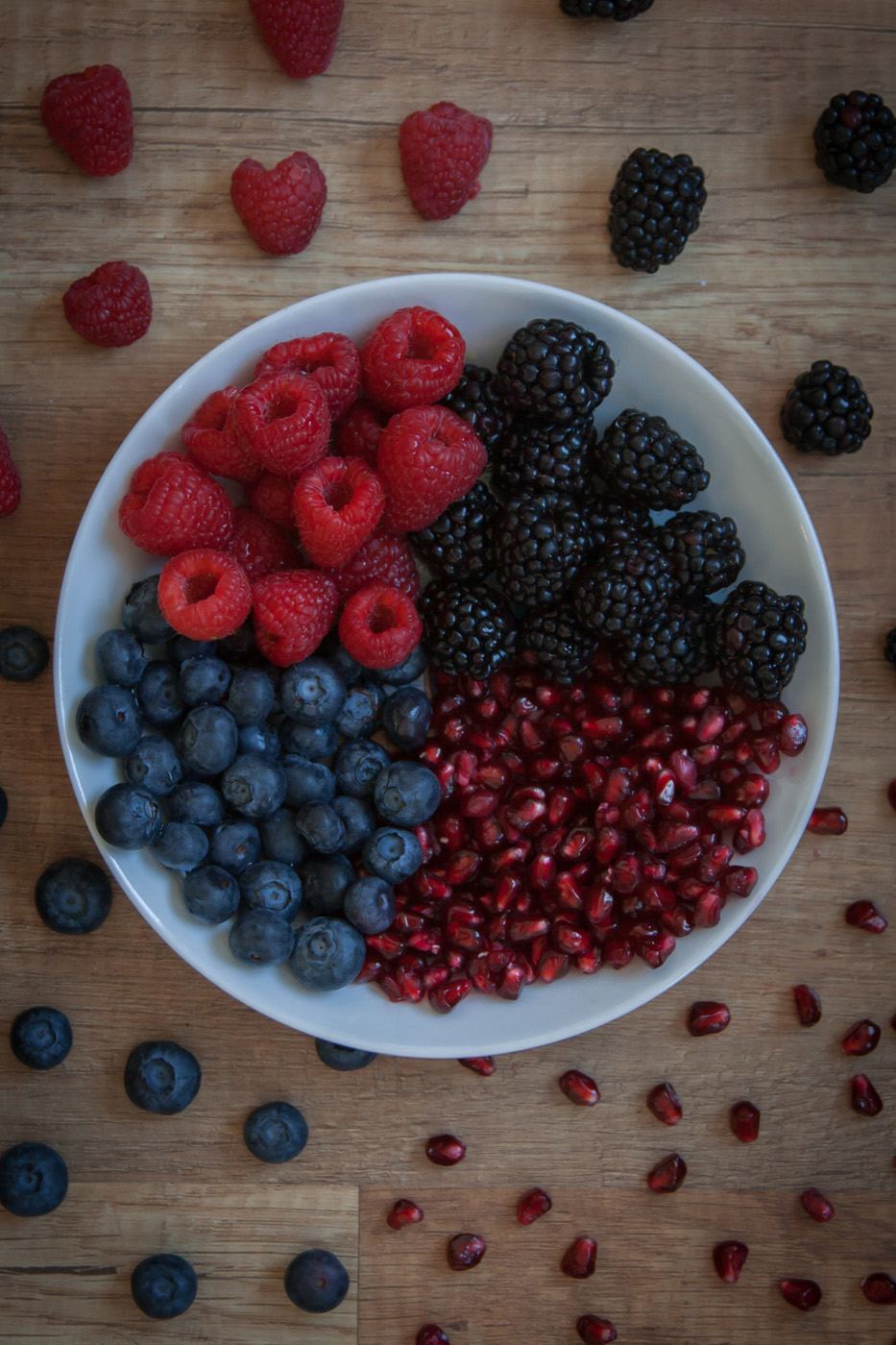 bowl of raspberries, blackberries, blueberries, and pomegranate seeds