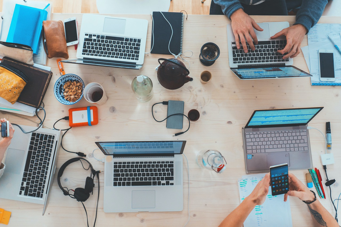 work desk covered with computers and digital devices