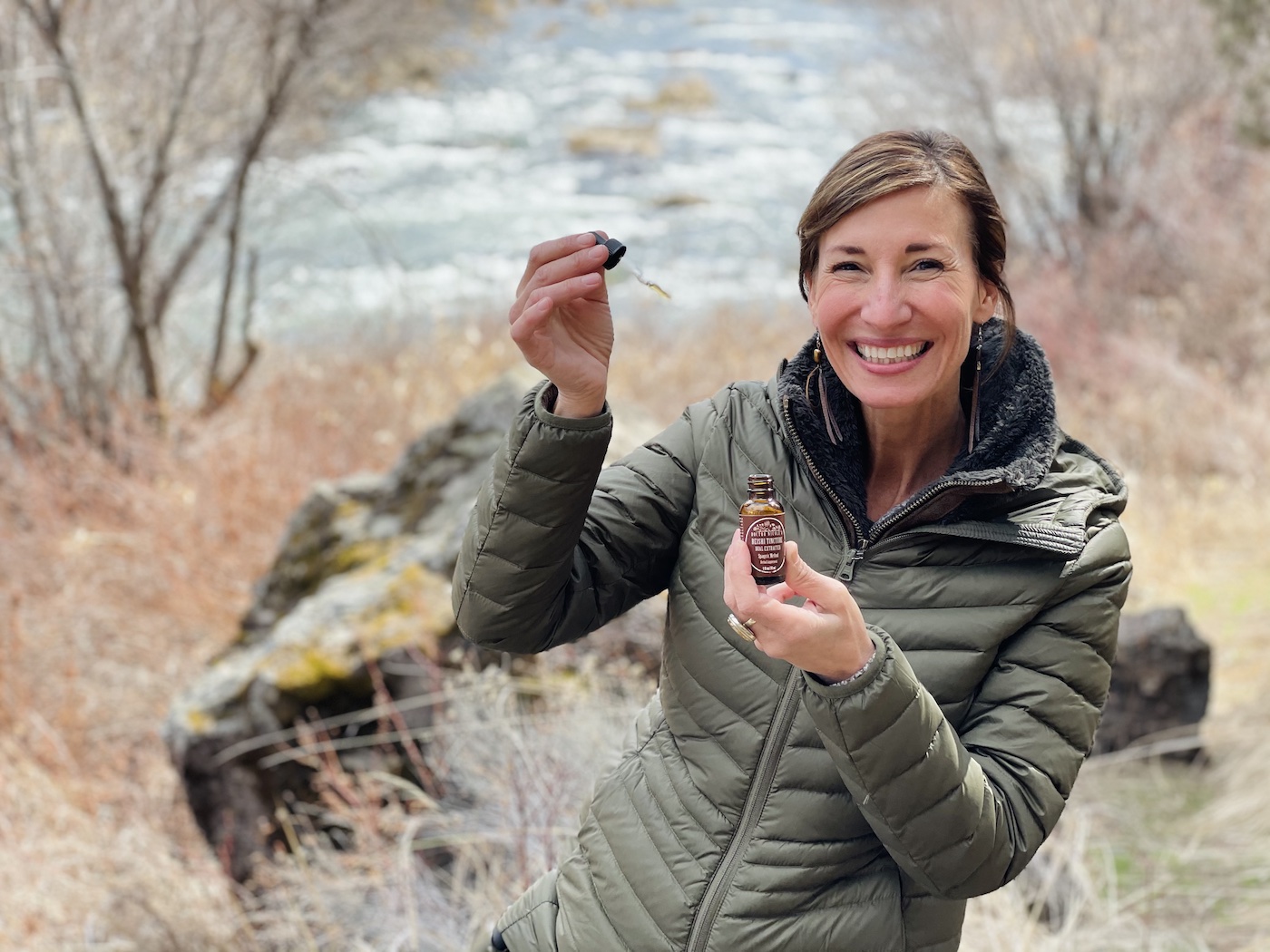 Nicole Apelian holding Reishi Mushroom Tincture dropper and bottle