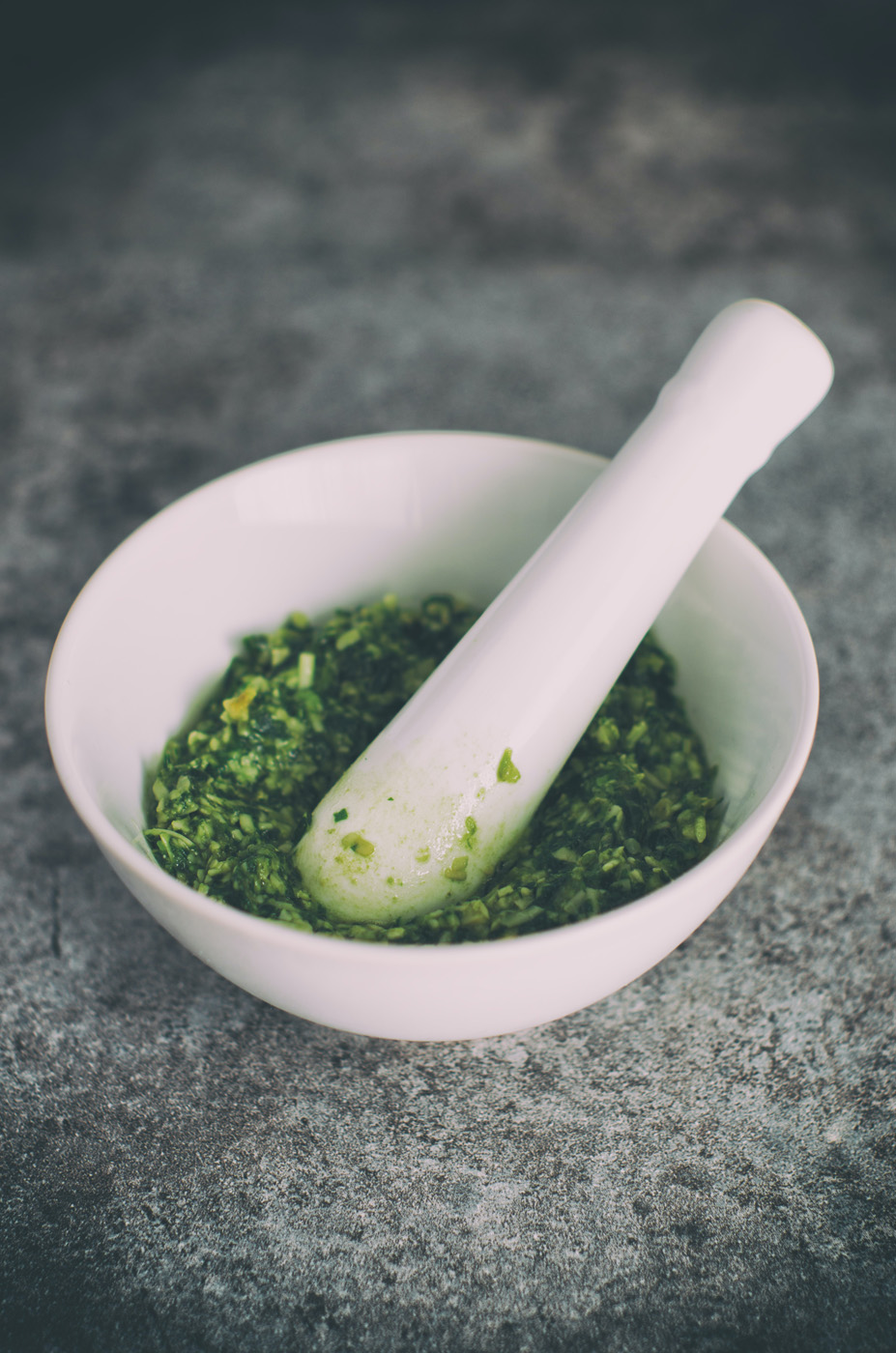 crushed stinging nettle in mortar with pestle