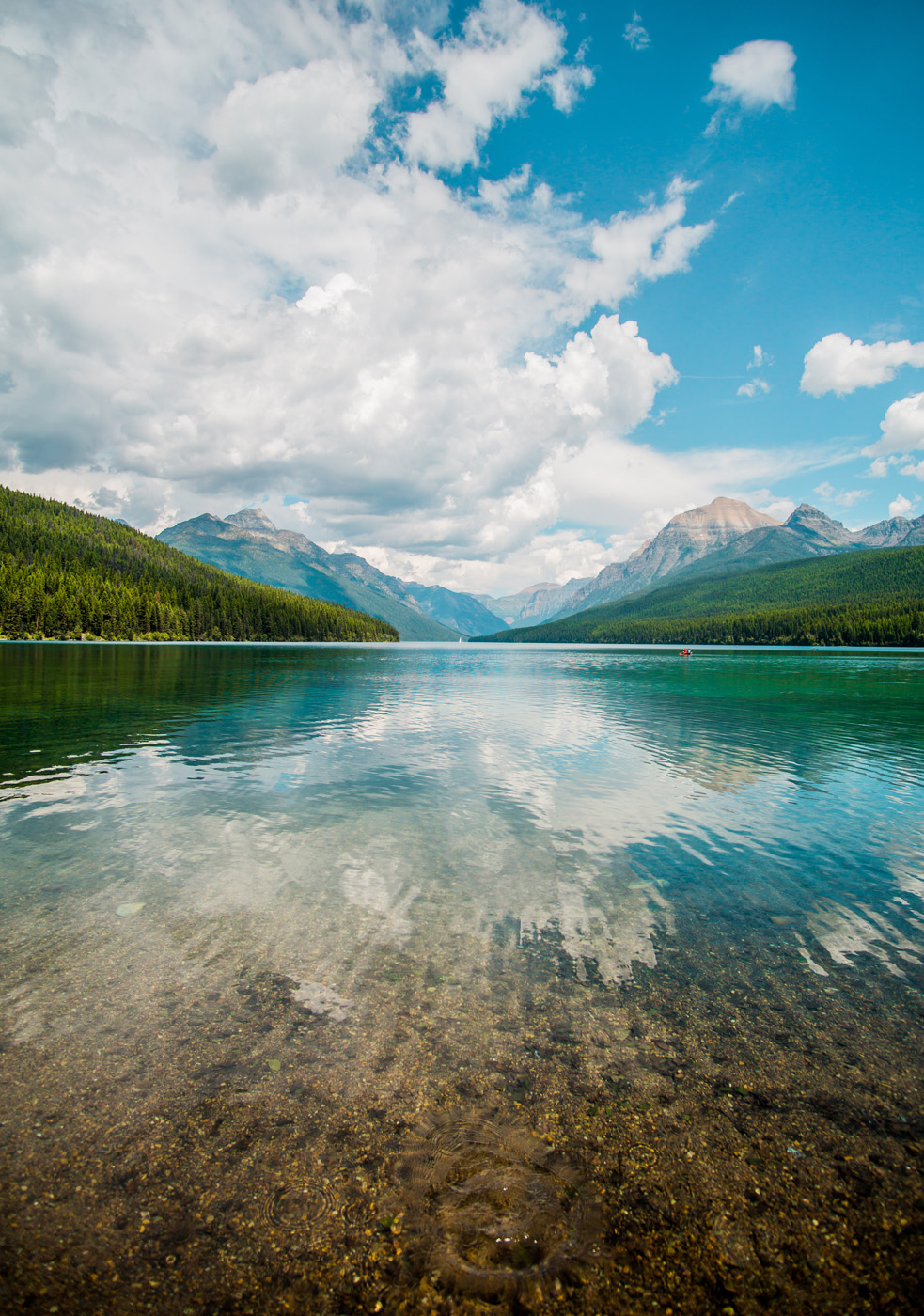 reflective lake with mountains in background