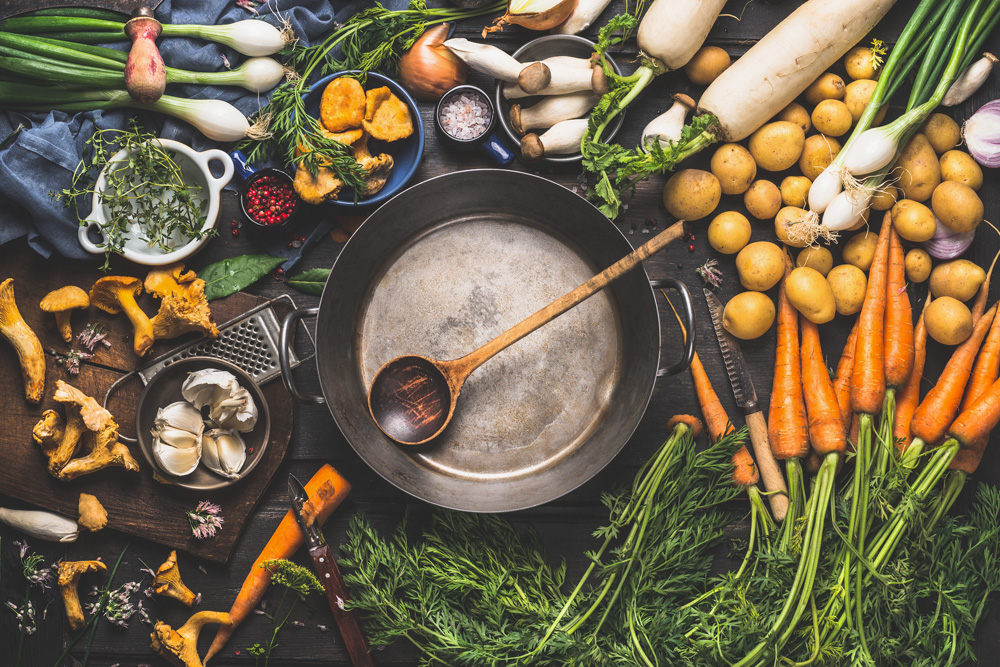 preparing vegetables herbs and mushrooms on a table