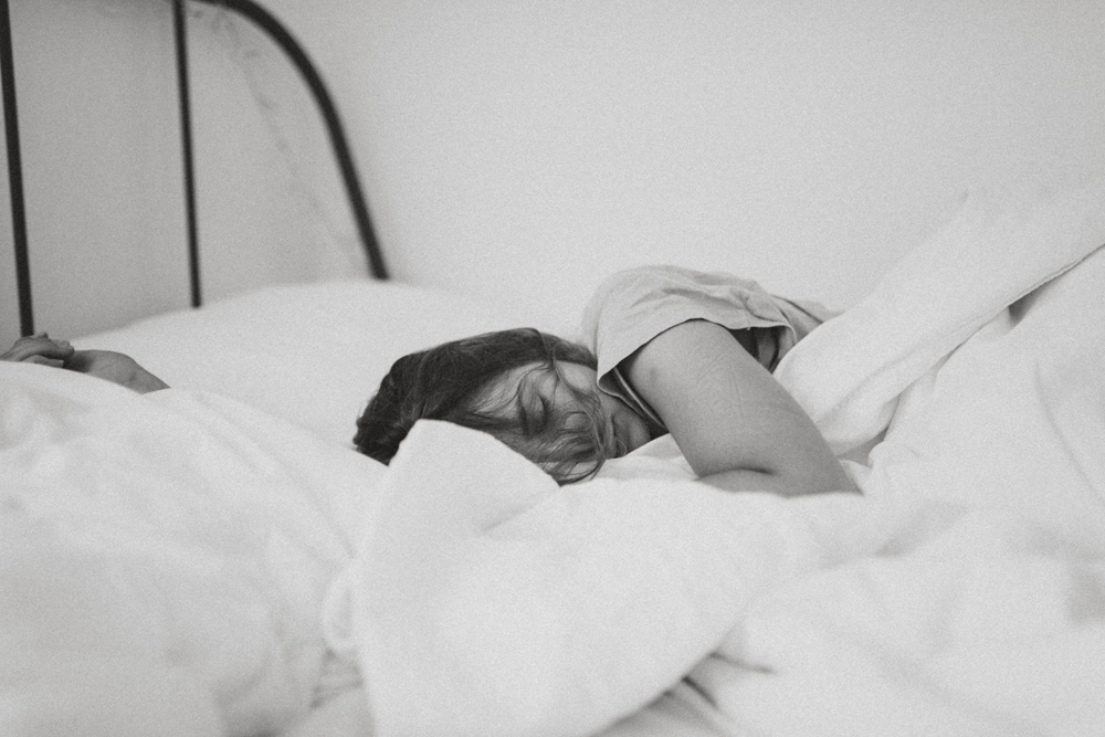 woman sleeping in bed chronic fatigue syndrome