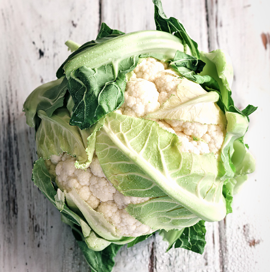 head of cauliflower on whitewashed table