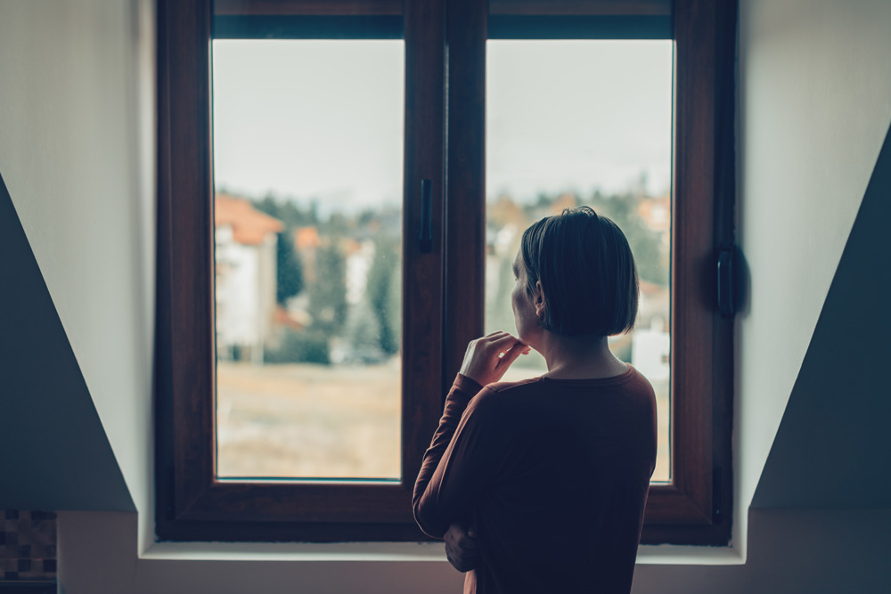 Sad woman looking out of the window