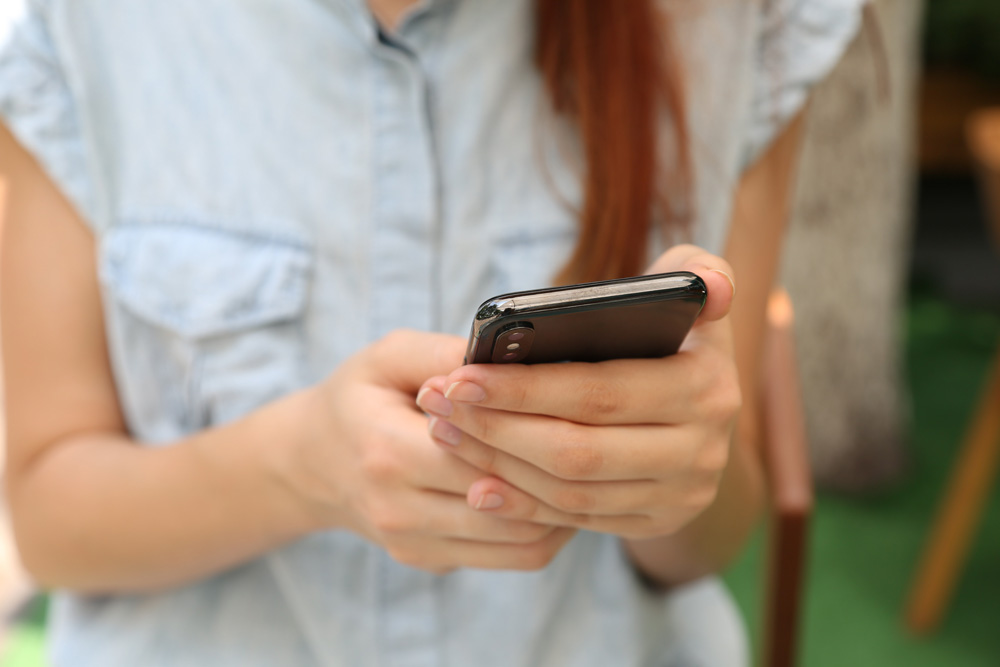 woman texting on mobile phone