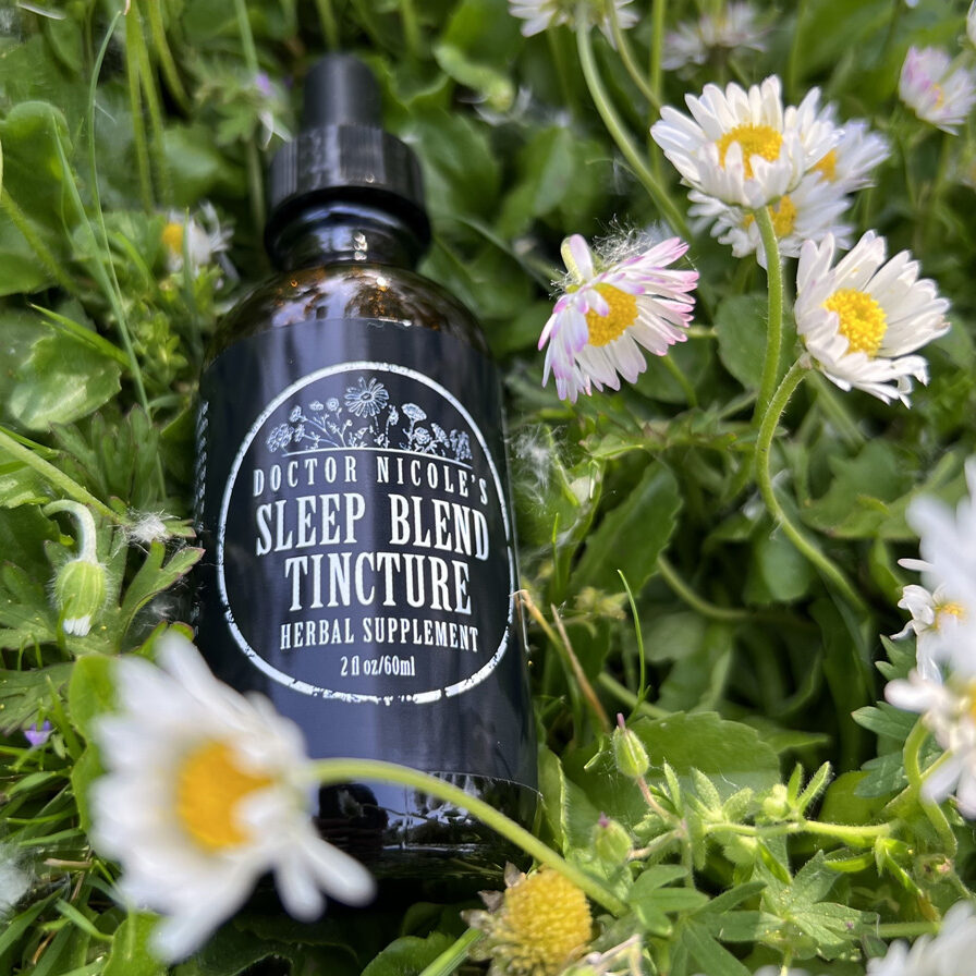 Nicoles Apothecary Sleep Blend Tincture in bed of chamomile