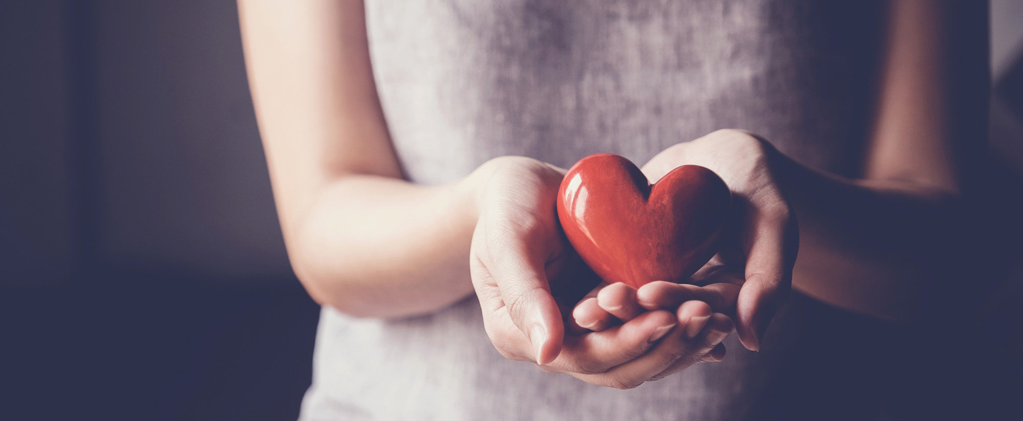 Close-up of woman holding red heart shape