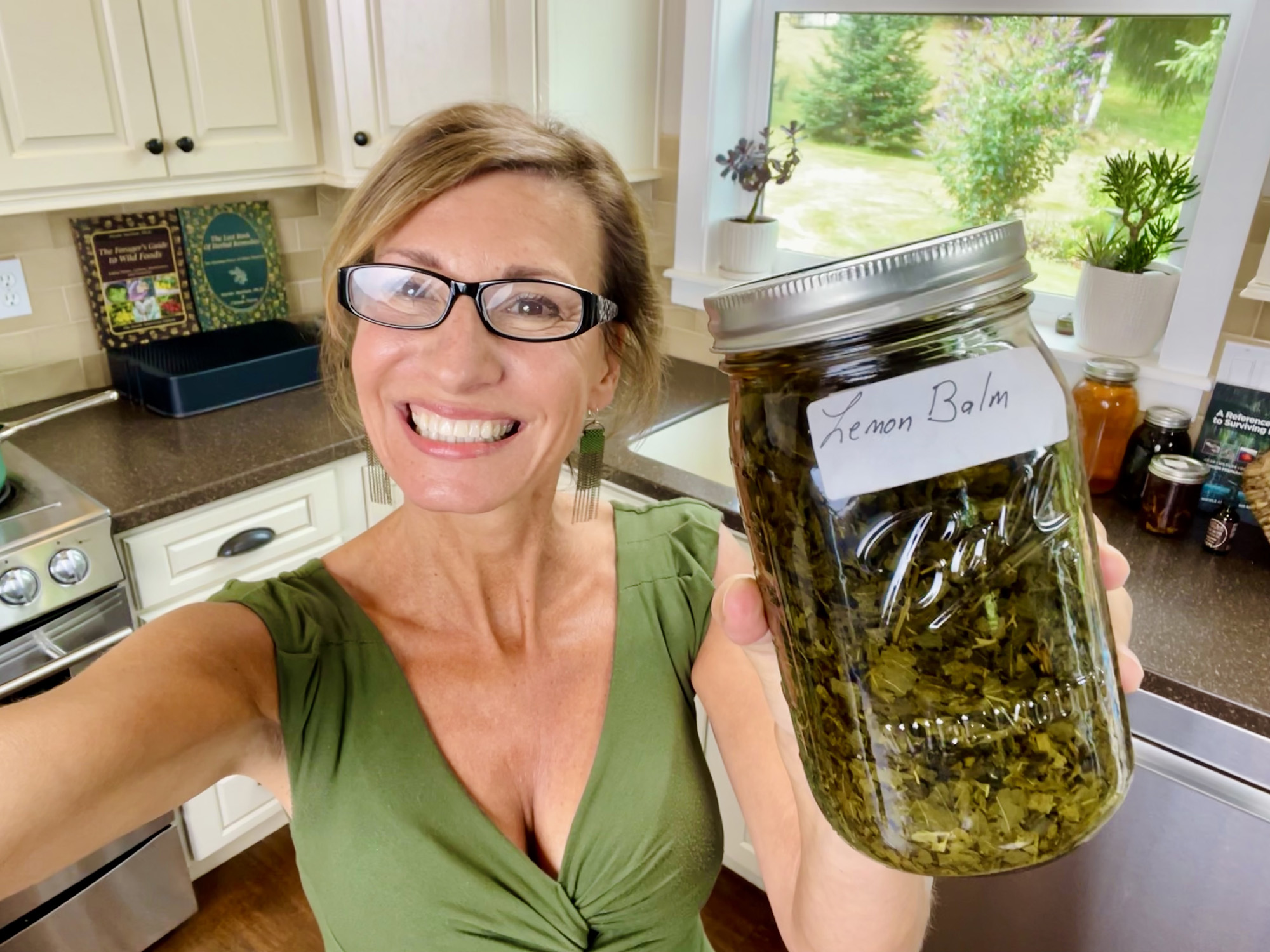 Nicole Apelian making lemon balm tincture in her kitchen