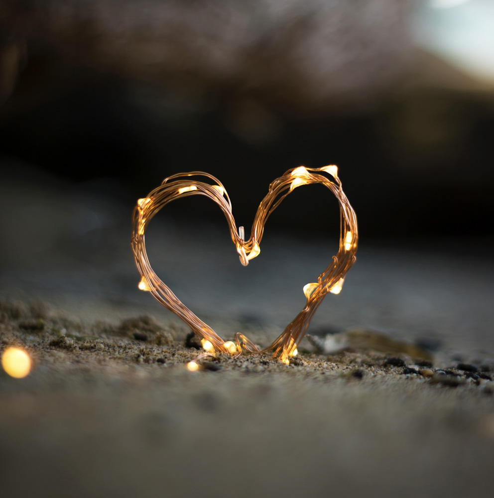 heart shaped string lights in the sand