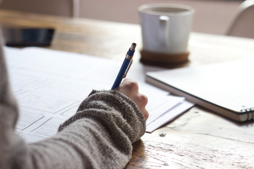 person journaling at their desk