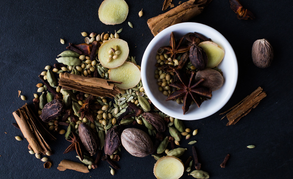 assortment of warming spices clove cinnamon ginger cardamom