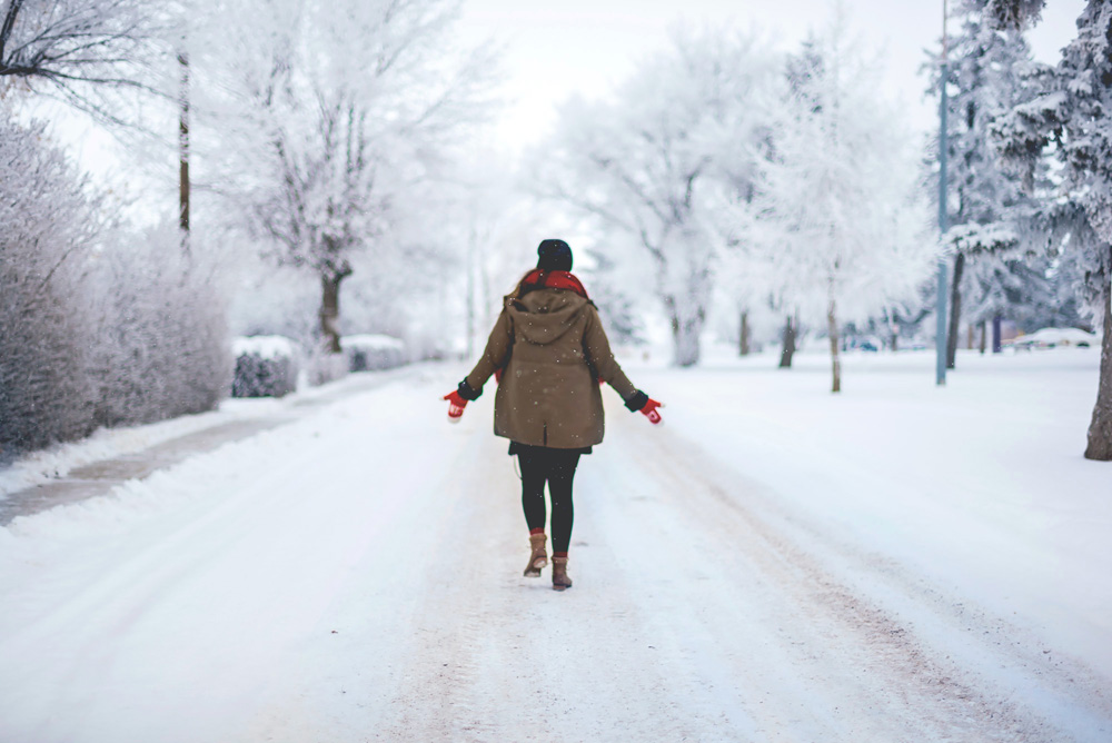 woman bundled up walking in the snow