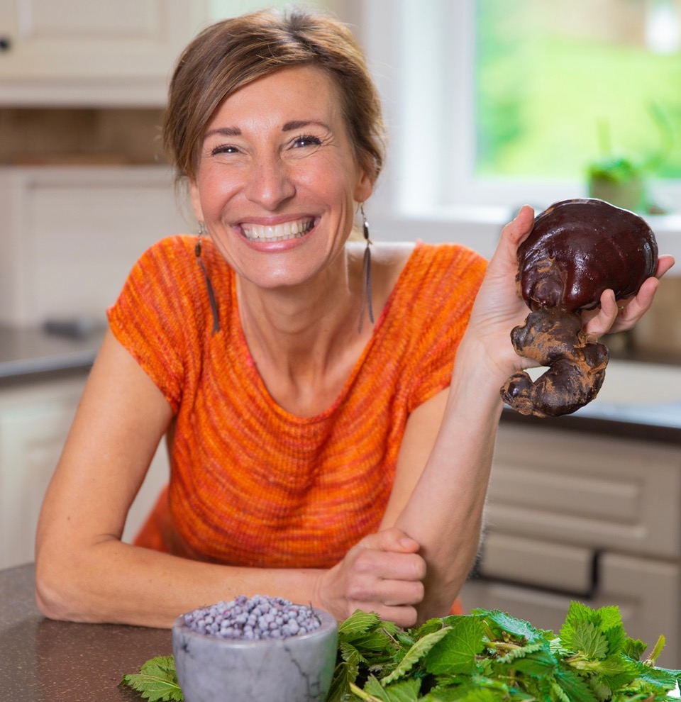 Nicole Apelian holding Reishi mushroom in kitchen