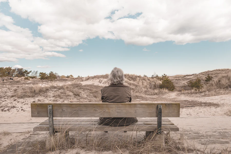 person sitting alone on bench