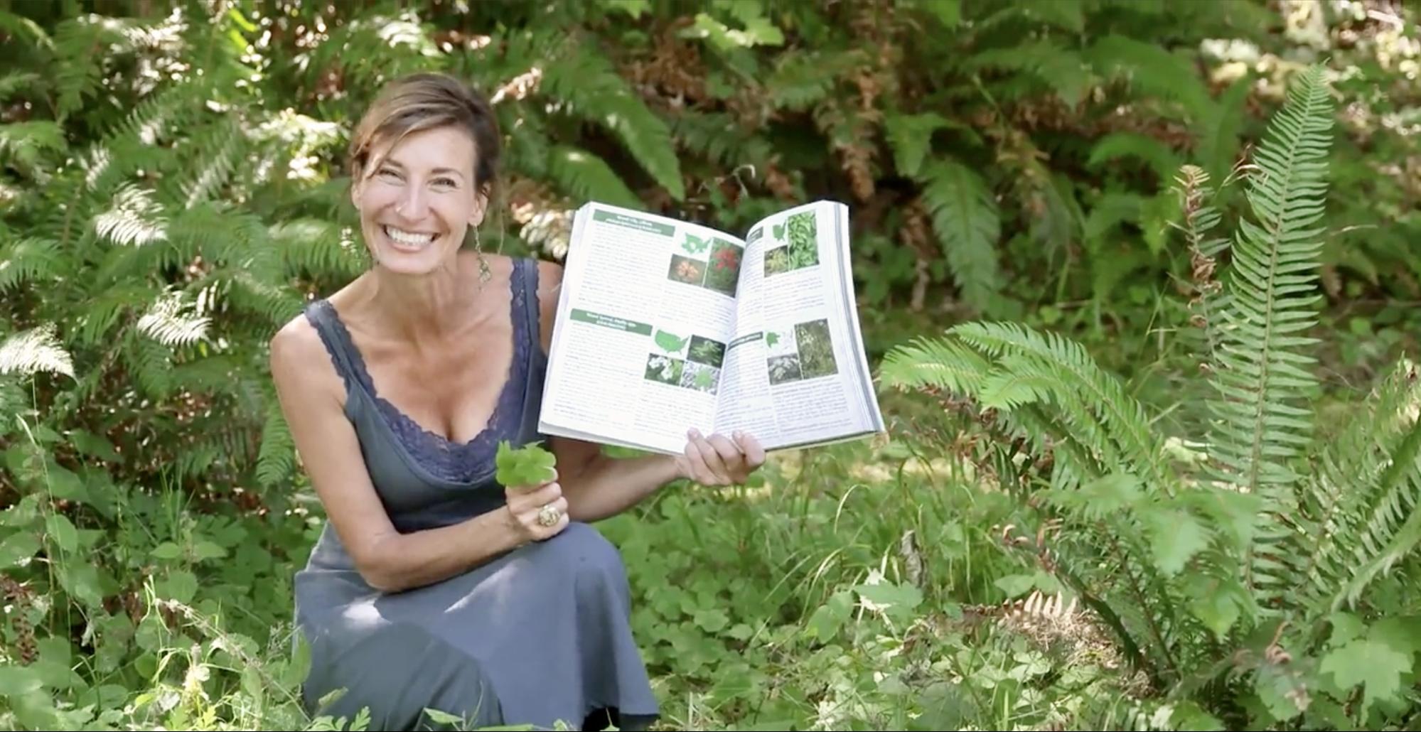 Nicole Apelian holding her foraging guide book