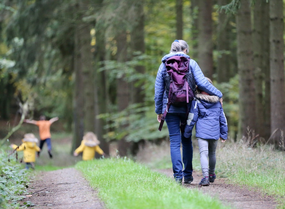 family hiking through woods
