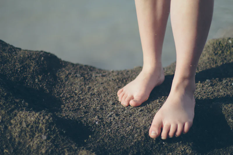 bare feet standing in dirt
