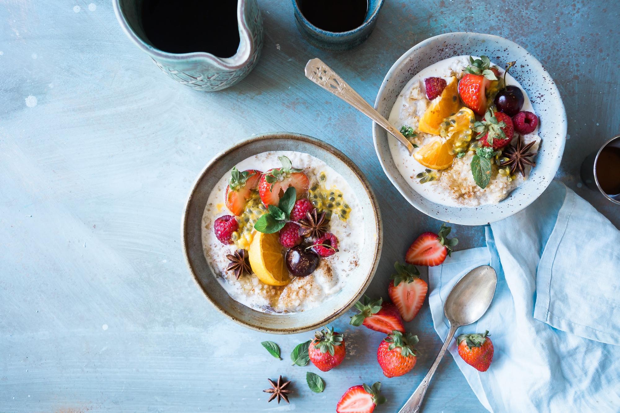 bowls of oatmeal with fresh berries and fruit