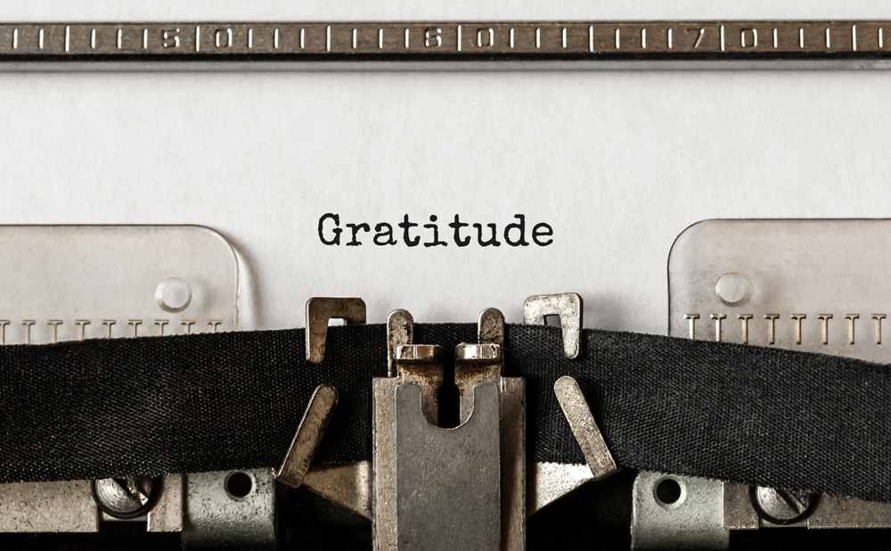 Text Gratitude typed on retro typewriter