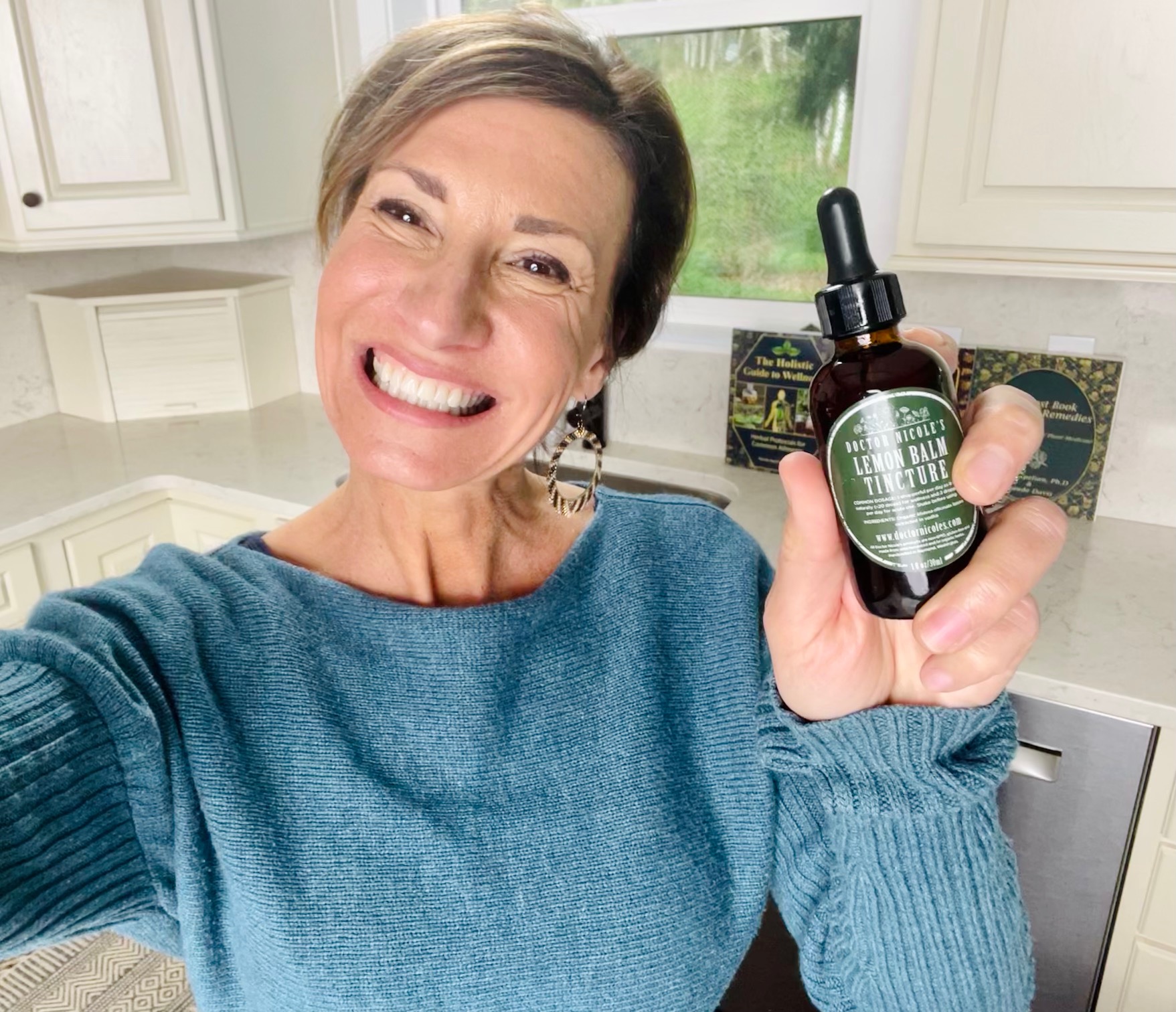 Nicole Apelian holding Nicoles Apothecary Lemon Balm Tincture