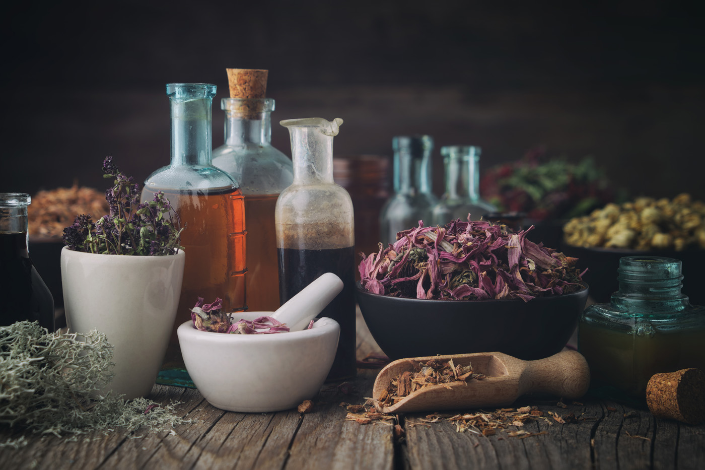 Bottles of healthy tincture or infusion, mortar and bowls of med