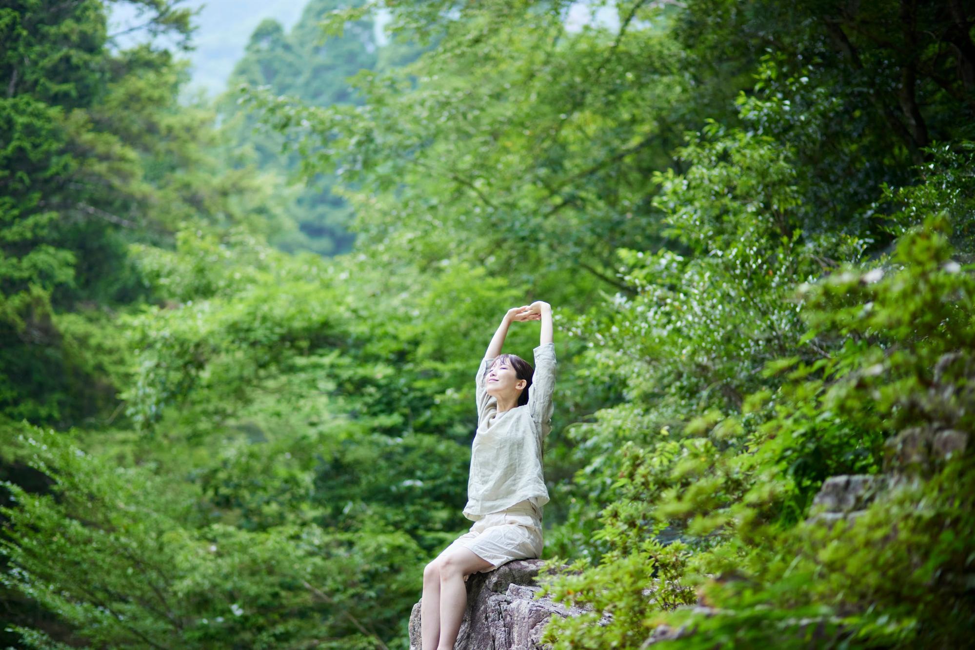 woman stretching in the woods