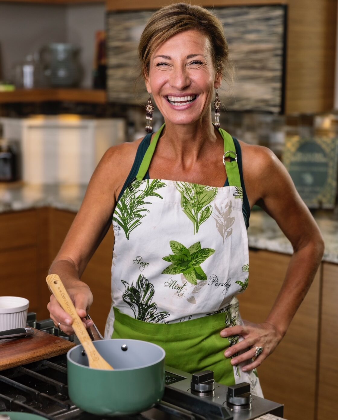Nicole Apelian stirring pot in kitchen