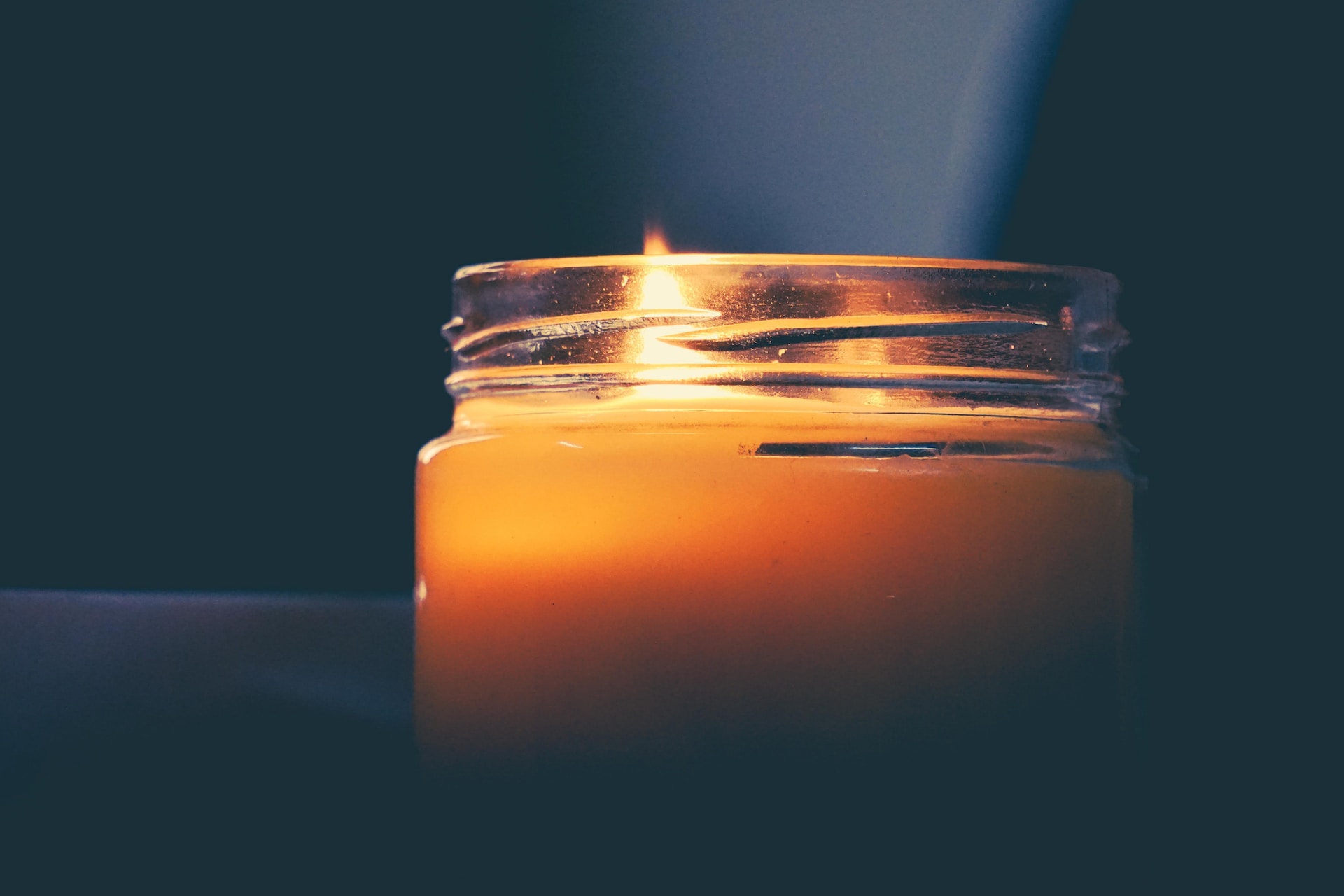 lit candle in jar
