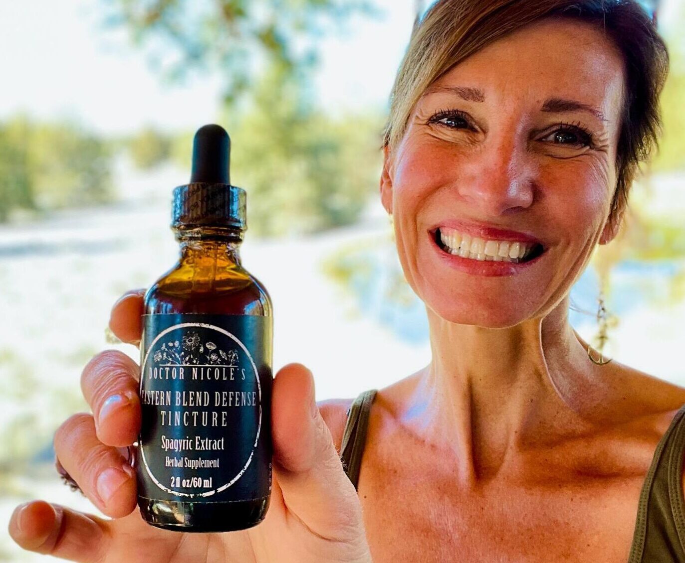 Nicoles Apothecary Bronchial Blend tincture Nicole Apelian holding Eastern Blend Defense Tincture