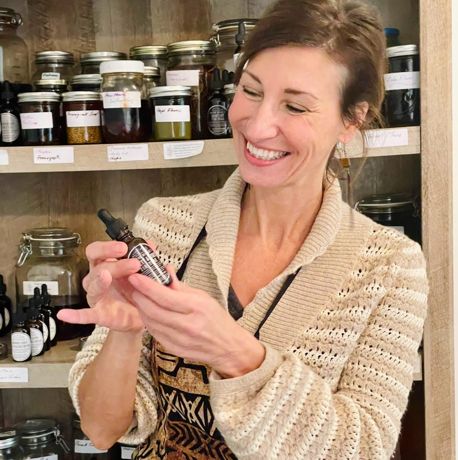 Nicole Apelian holding tincture from Apothecary