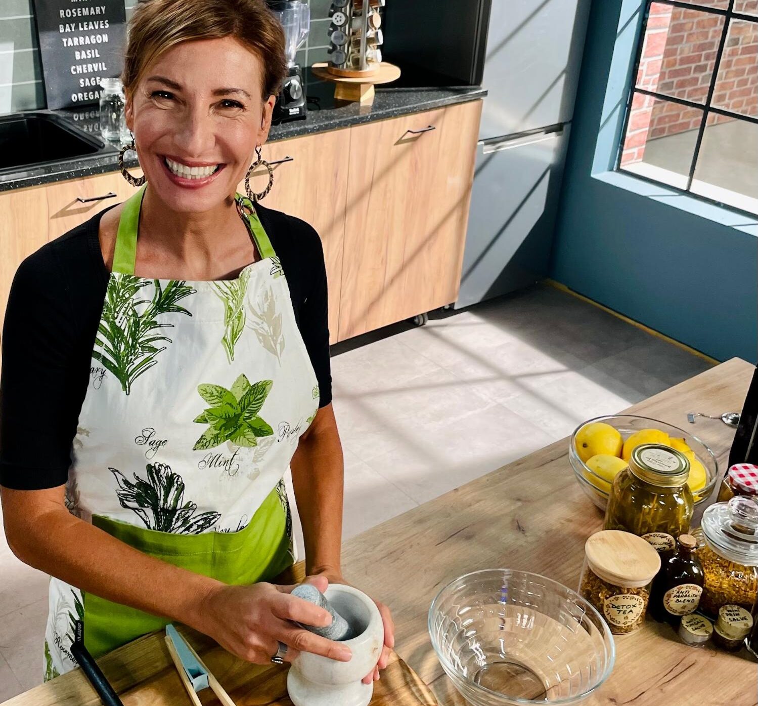 Nicole Apelian preparing herbs in her kitchen