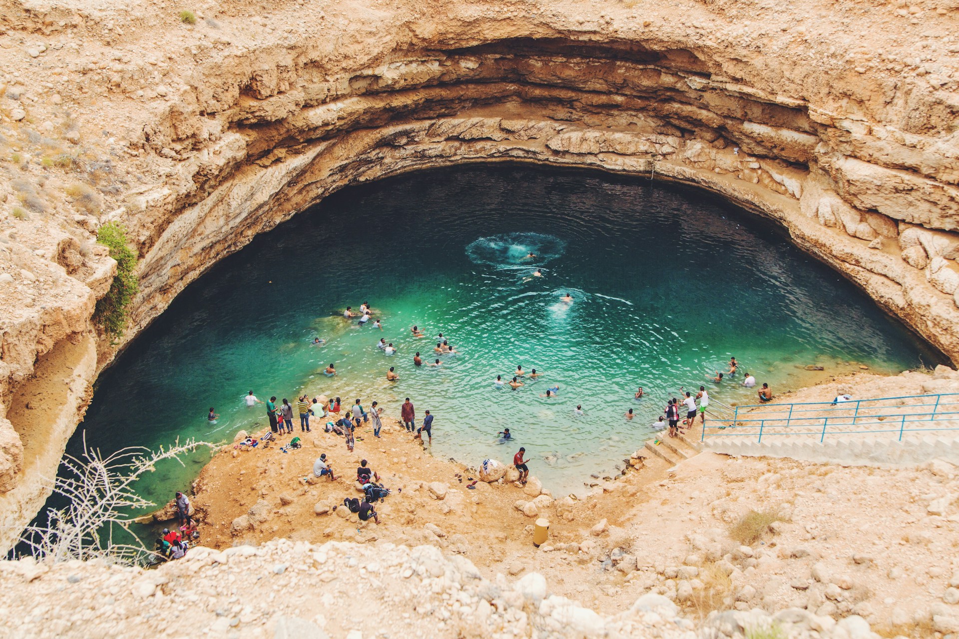 people at a swimming hole in a cavern