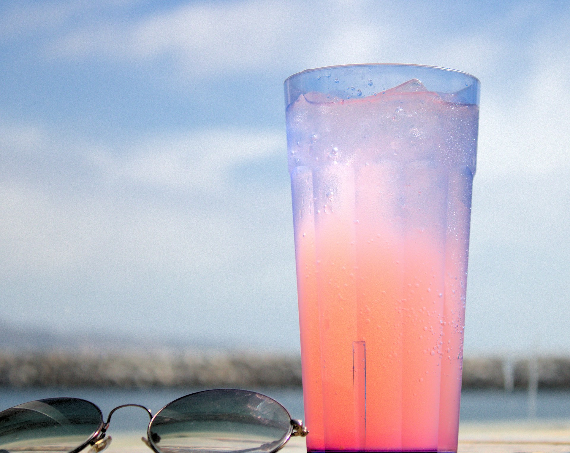 refreshing pink drink and sunglasses
