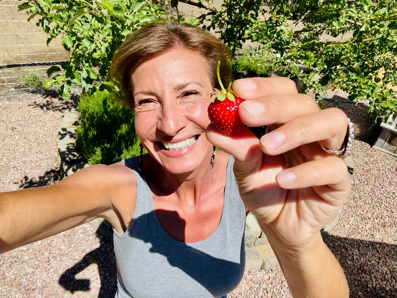 Nicole Apelian holding freshly picked strawberry