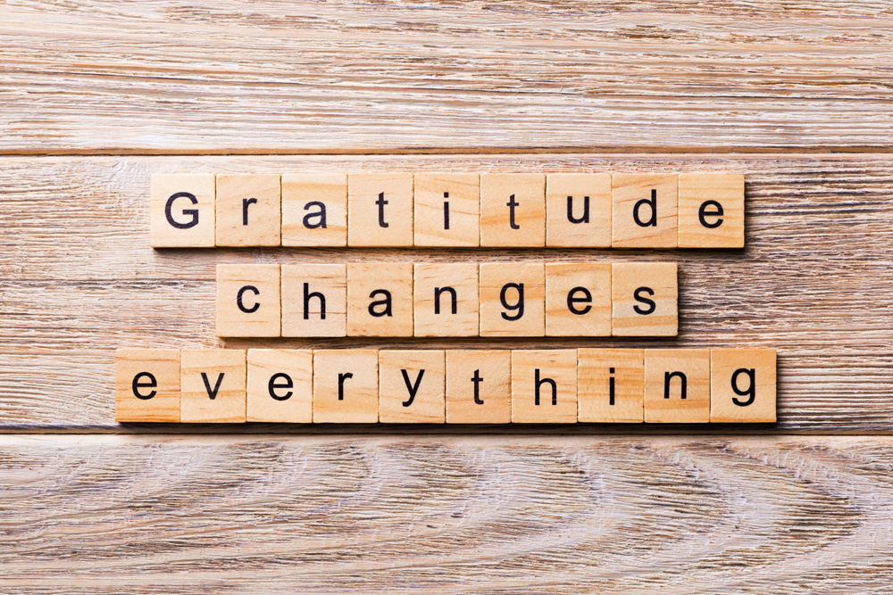 Gratitude changes everything word written on wood block. Gratitude changes everything scrabble tiles