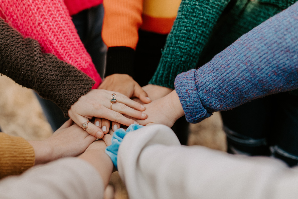 many hands clasped together