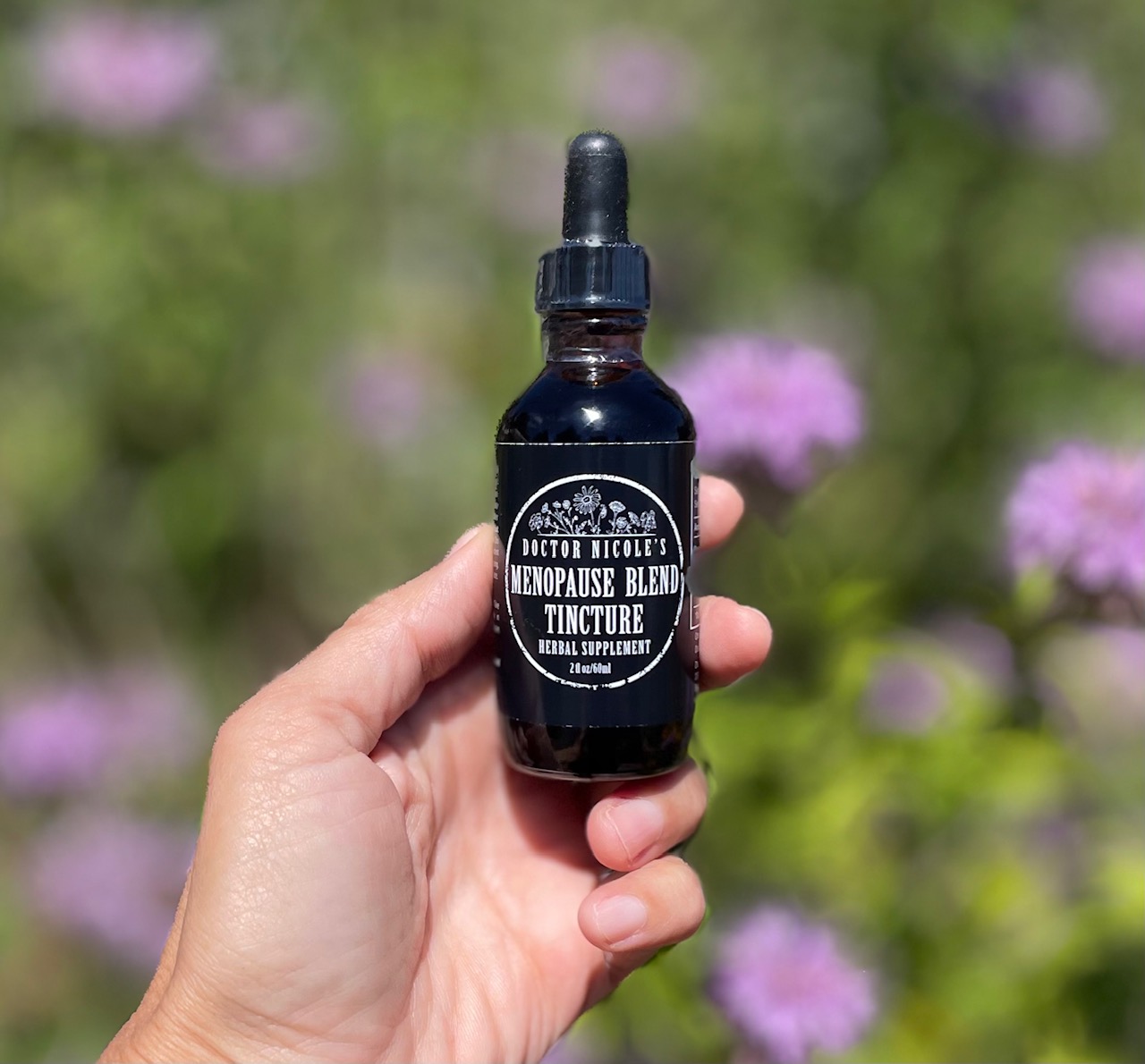 hand holding Nicole's Apothecary Menopause Blend Tincture