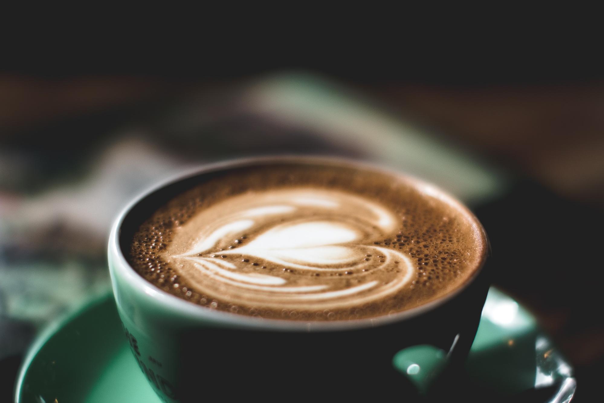 heart latte art in green cup