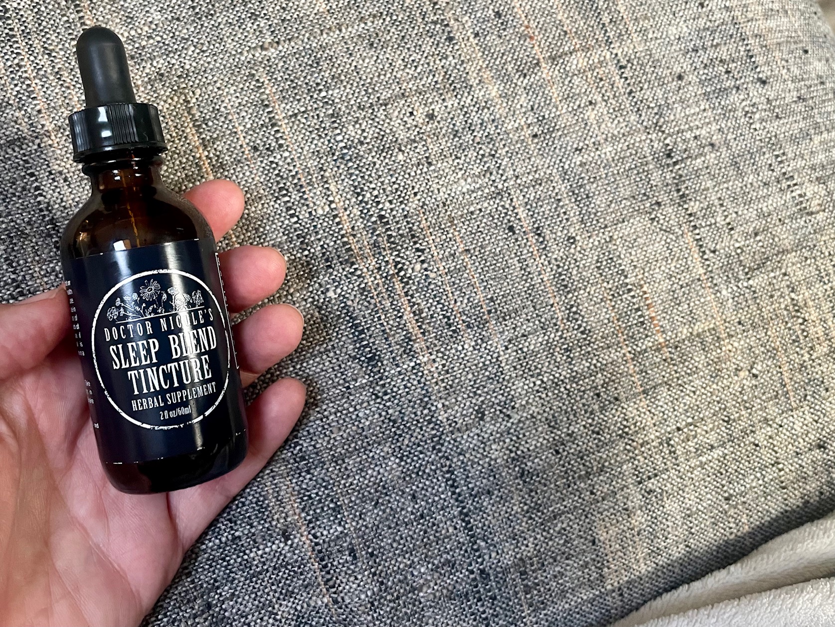 Nicole Apelian holding Sleep Blend tincture