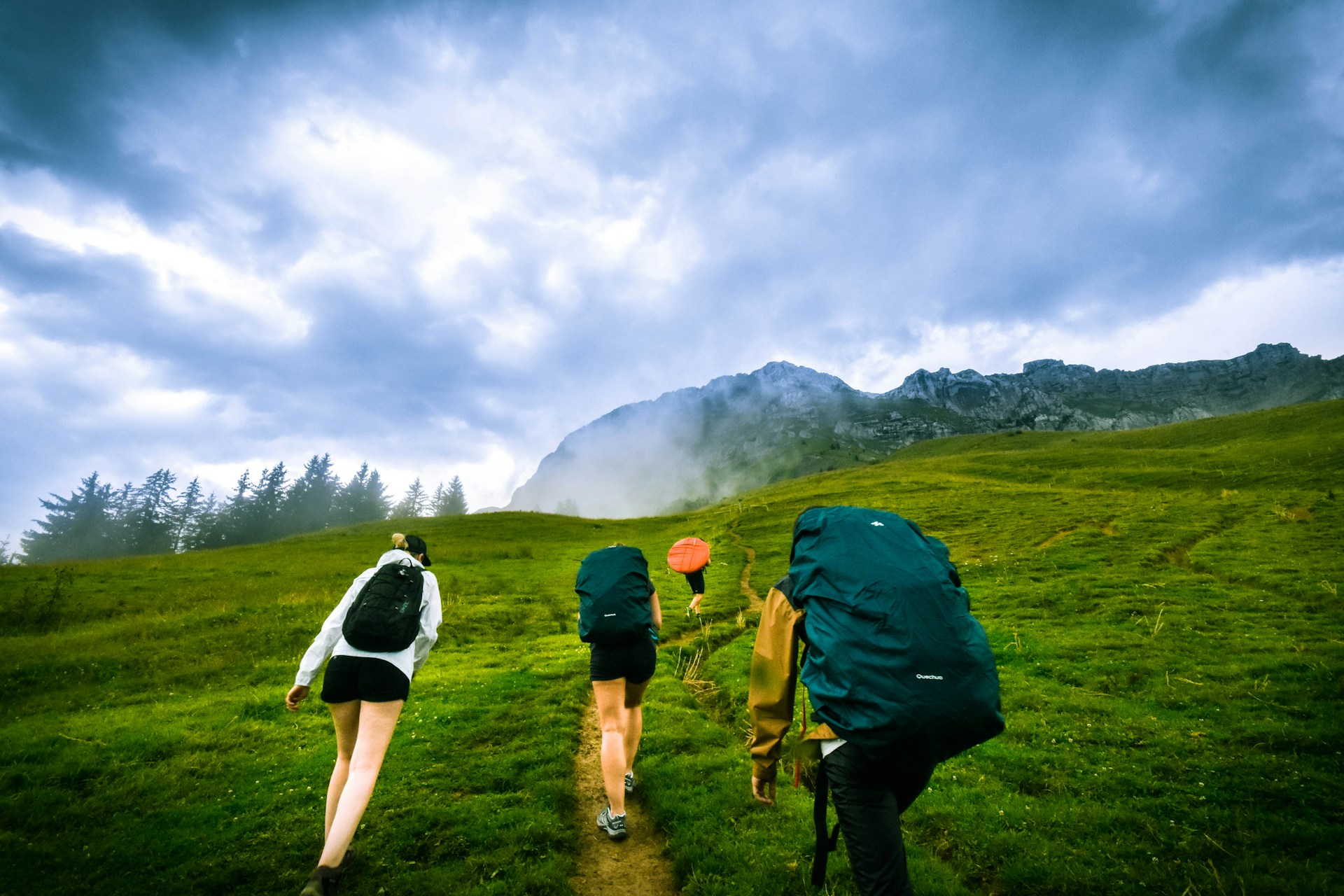 hikers trekking up hillside