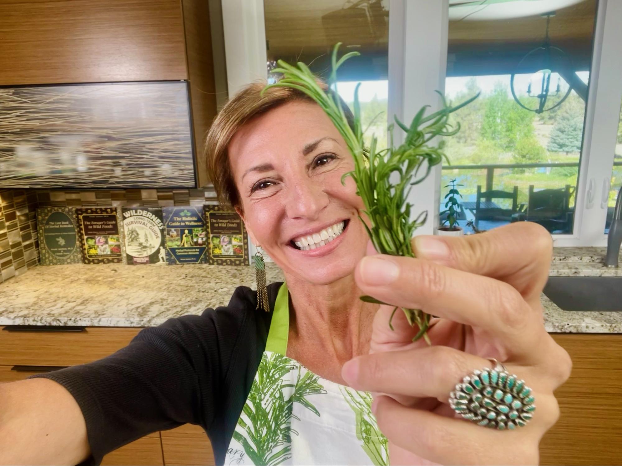 Nicole Apelian holding fresh rosemary in the kitchen Herbal Focus: Rosemary <span class="latin">Rosmarinus officinalis</span>