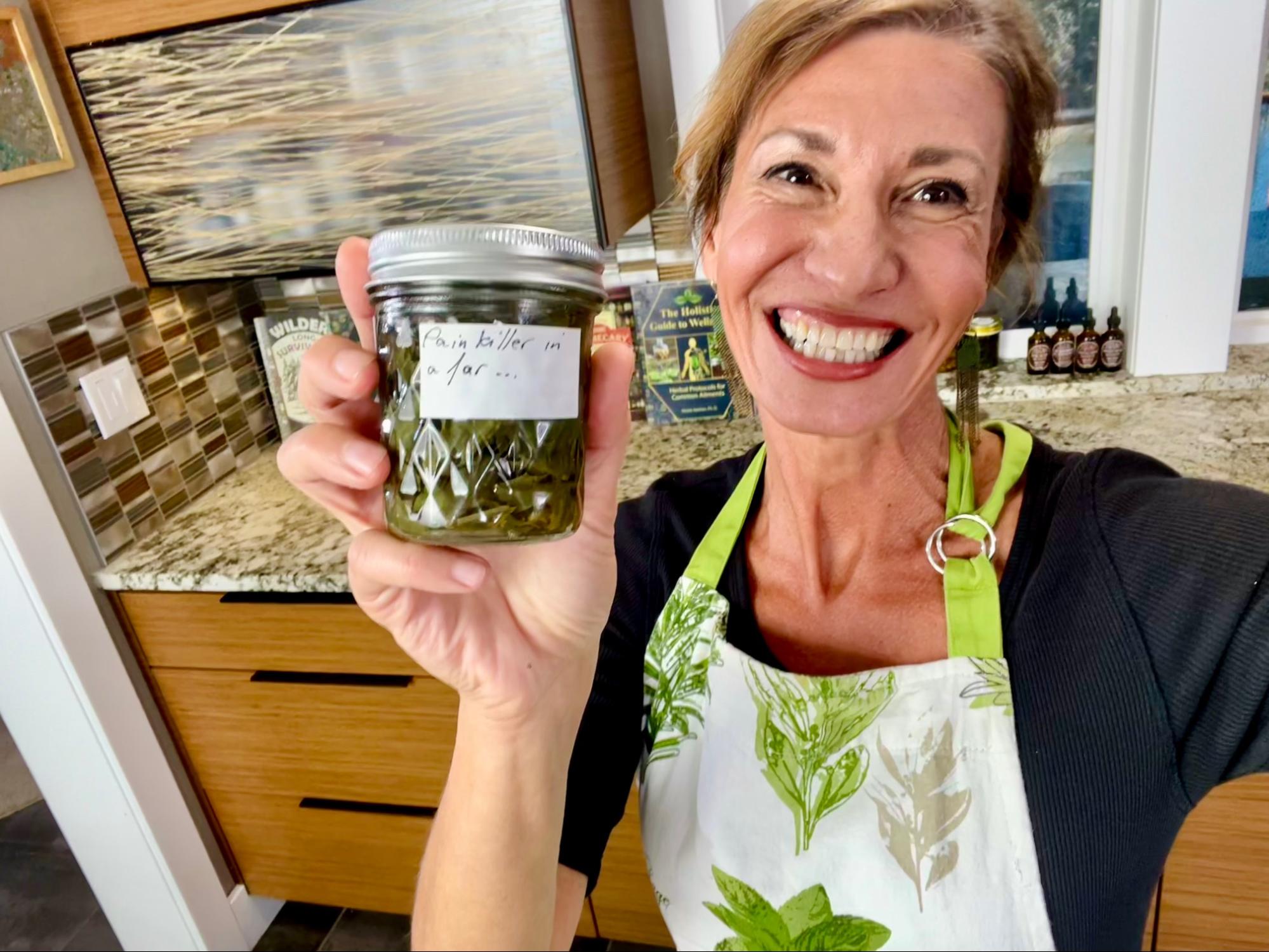 Nicole Apelian holding her Pain Killer in a Jar tincture