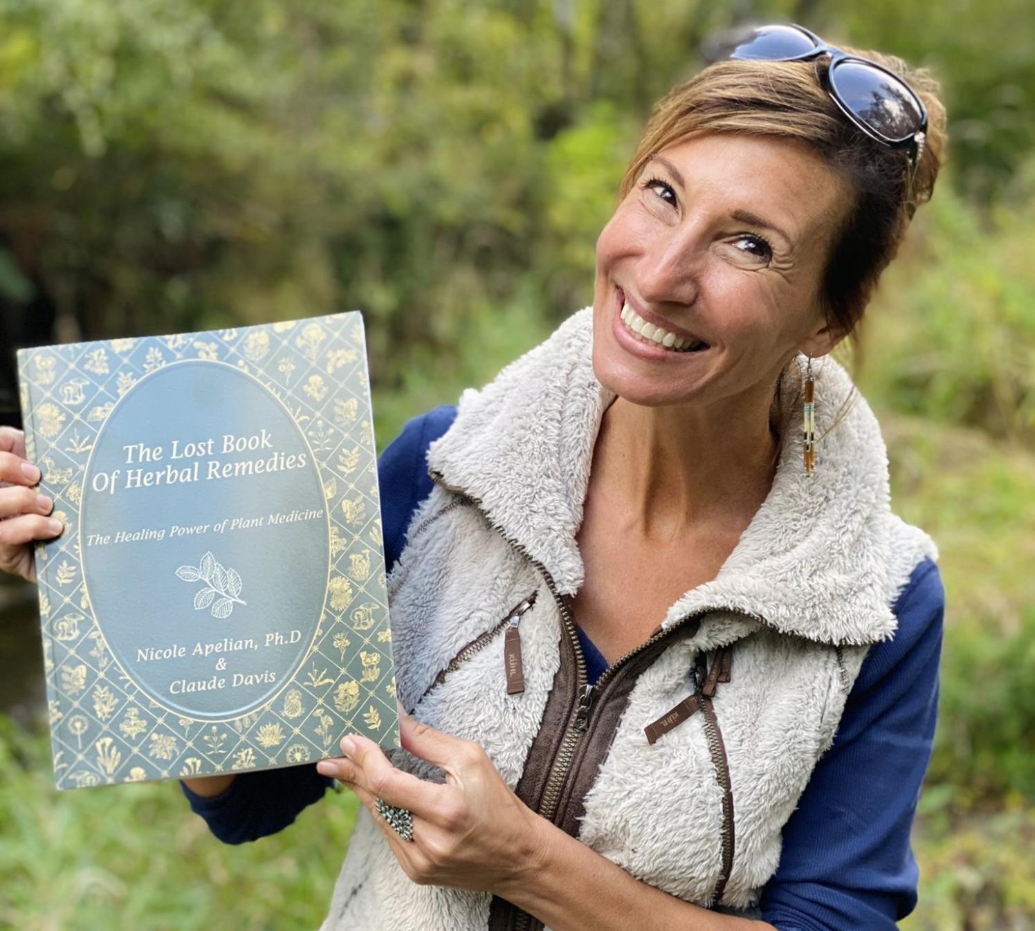 Nicoles Apothecary Bronchial Blend tincture Nicole Apelian holding Lost Book of Herbal Remedies