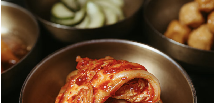 metal bowls of kimchi and ingredients