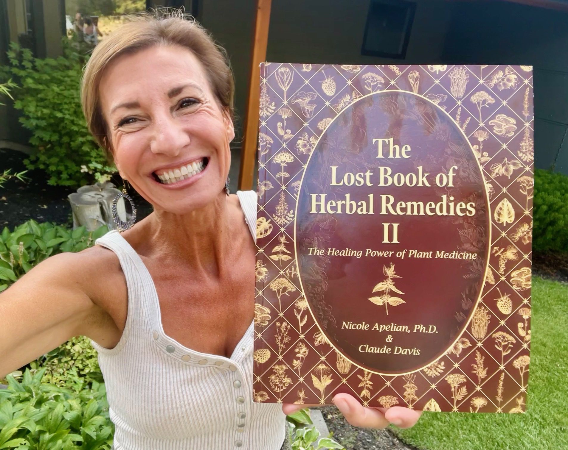 Nicole Apelian holding Lost Book of Herbal Remedies 2 Nicole Apelian holding Lost Book of Herbal Remedies 2